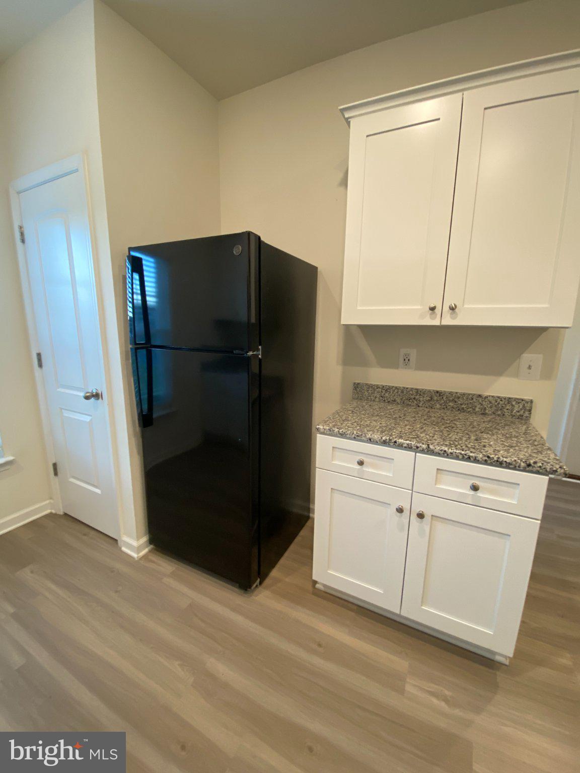 697 Rivanna Run Falling Waters, WV 25419 - Photo 8 of 44 a kitchen with granite countertop white cabinets and refrigerator