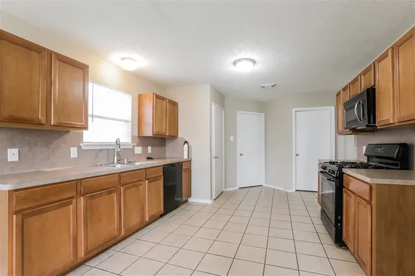 a kitchen with stainless steel appliances granite countertop a sink and cabinets