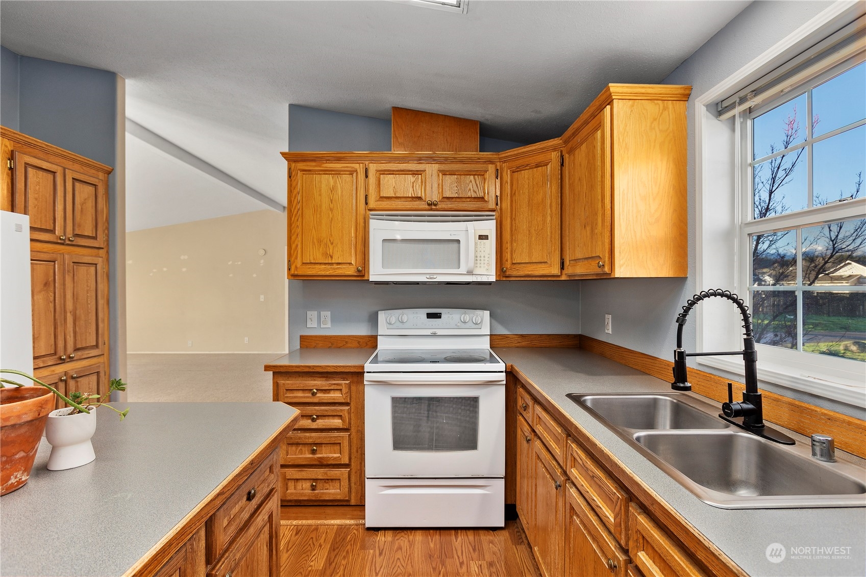 208 Carlsborg Road Sequim, WA 98382 - Photo 15 of 40 a kitchen that has a sink and a stove
