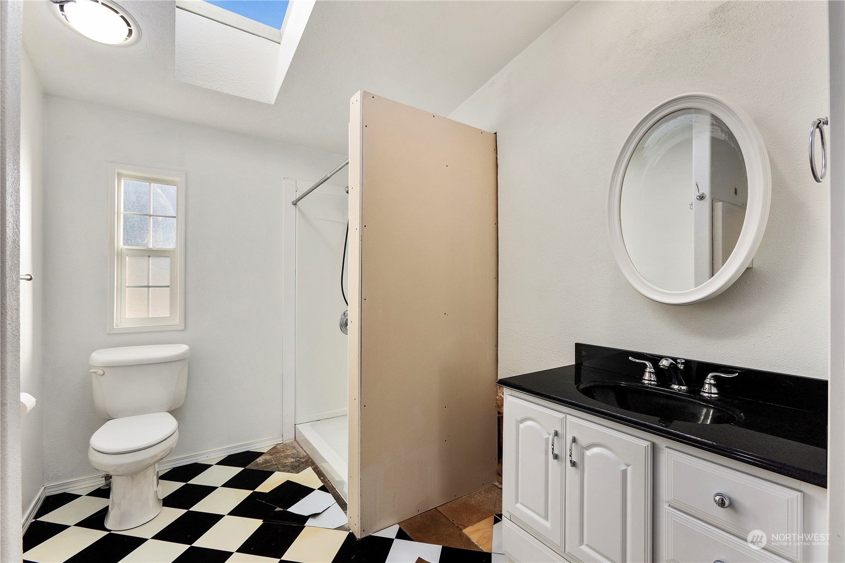 208 Carlsborg Road Sequim, WA 98382 - Photo 27 of 40 a bathroom with a sink a toilet and a mirror