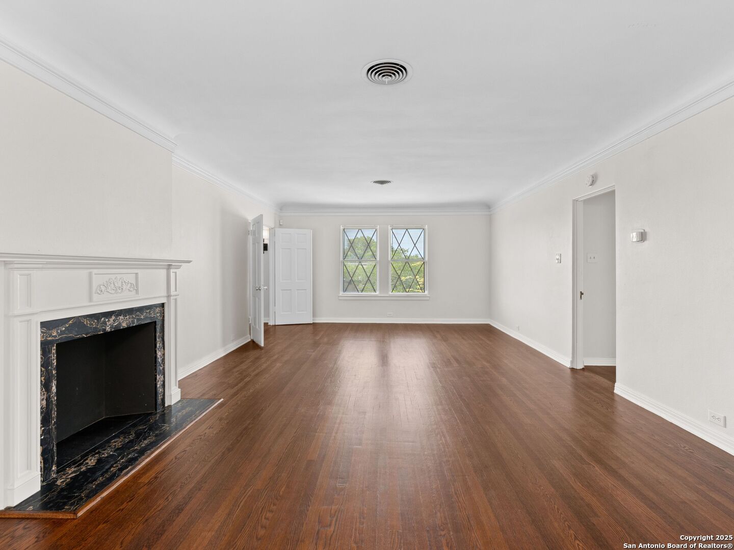 146 Terrell Road Alamo Heights, TX 78209 - Photo 12 of 29 an empty room with wooden floor fireplace and windows