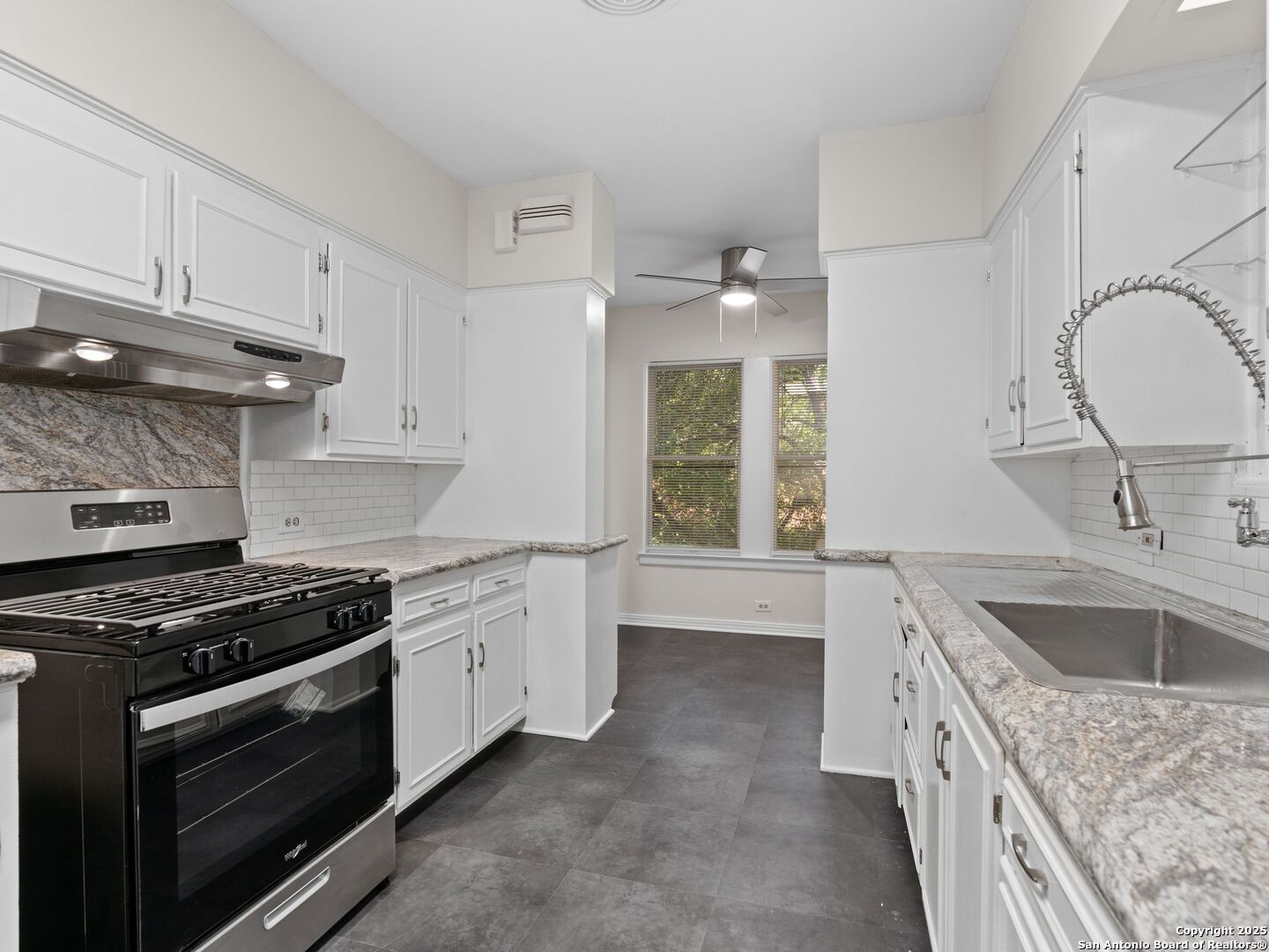 146 Terrell Road Alamo Heights, TX 78209 - Photo 16 of 29 a kitchen with granite countertop a sink stove and cabinets