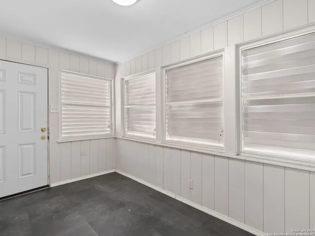 a kitchen with granite countertop a sink stove and cabinets
