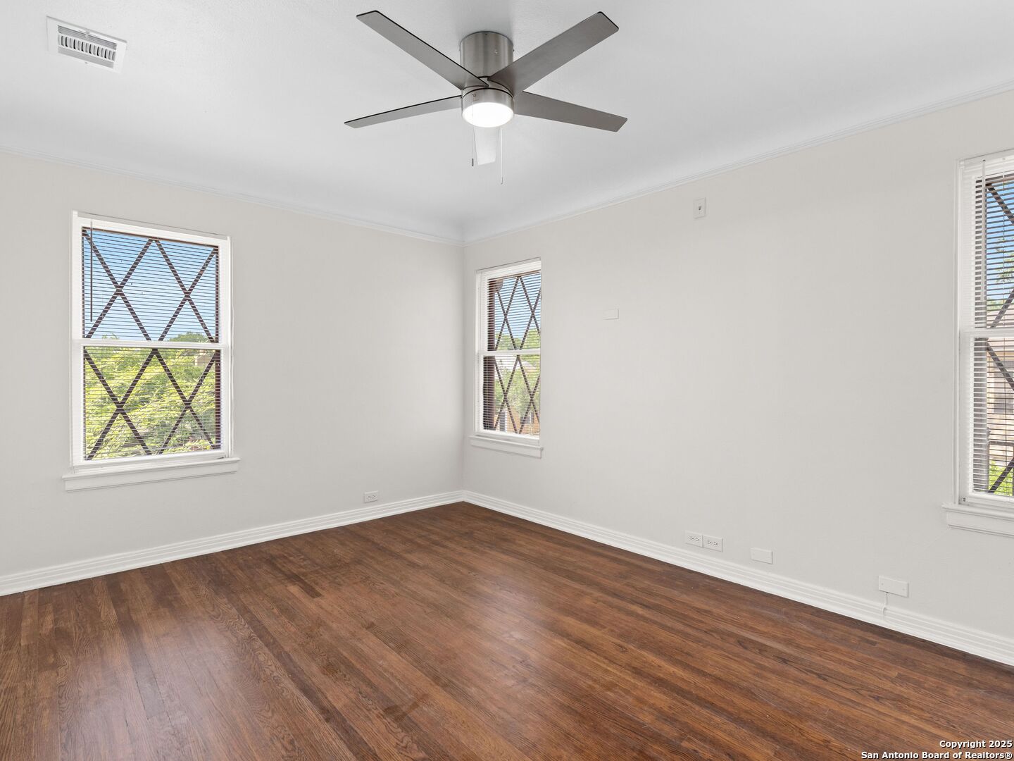 146 Terrell Road Alamo Heights, TX 78209 - Photo 24 of 29 a view of an empty room with wooden floor and a window