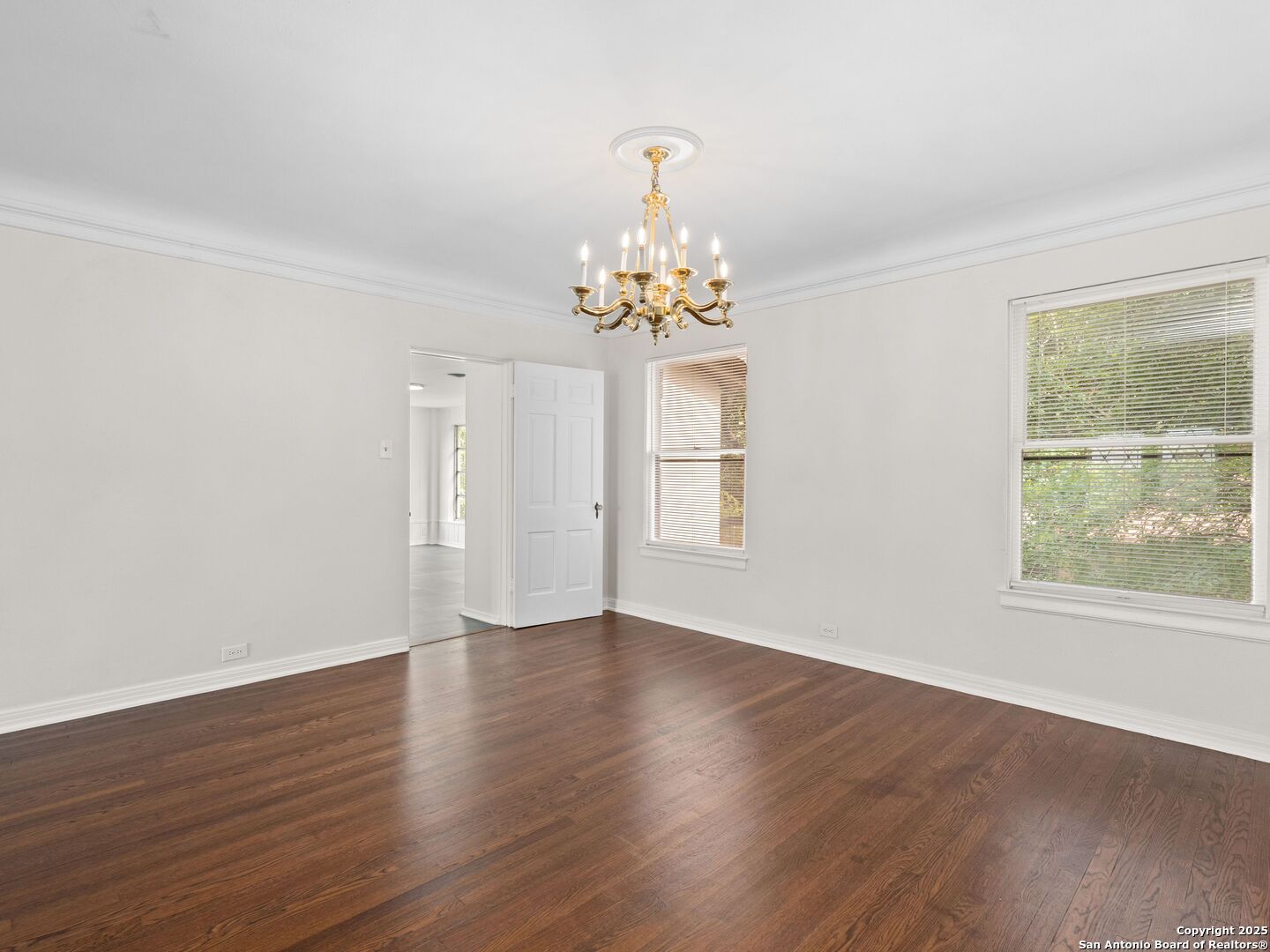 146 Terrell Road Alamo Heights, TX 78209 - Photo 9 of 29 a view of an empty room with wooden floor and a window