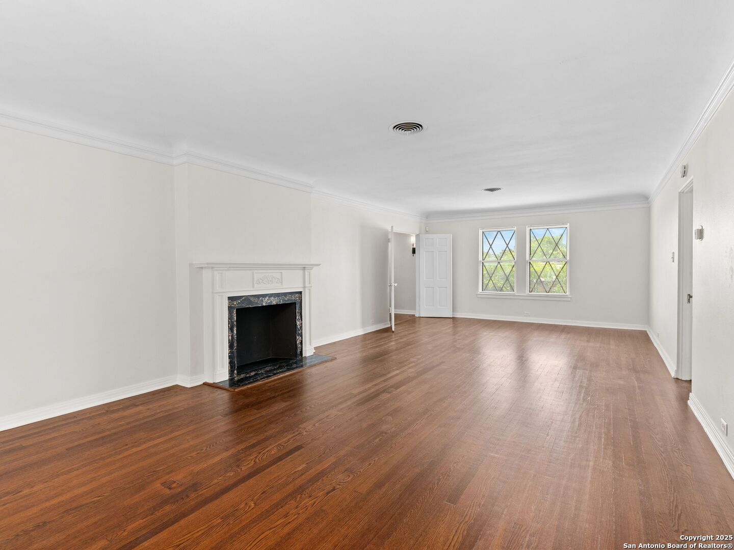 146 Terrell Road Alamo Heights, TX 78209 - Photo 10 of 29 a view of an empty room with window and wooden floor