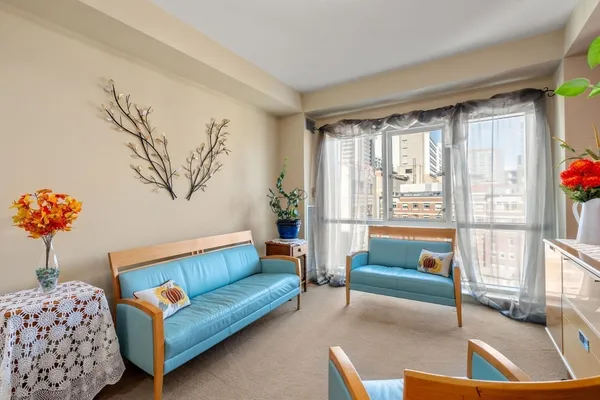 a living room with furniture and a large window