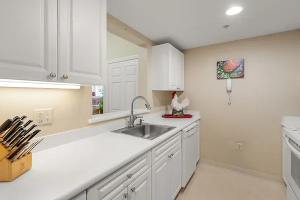 a kitchen with a sink and a refrigerator