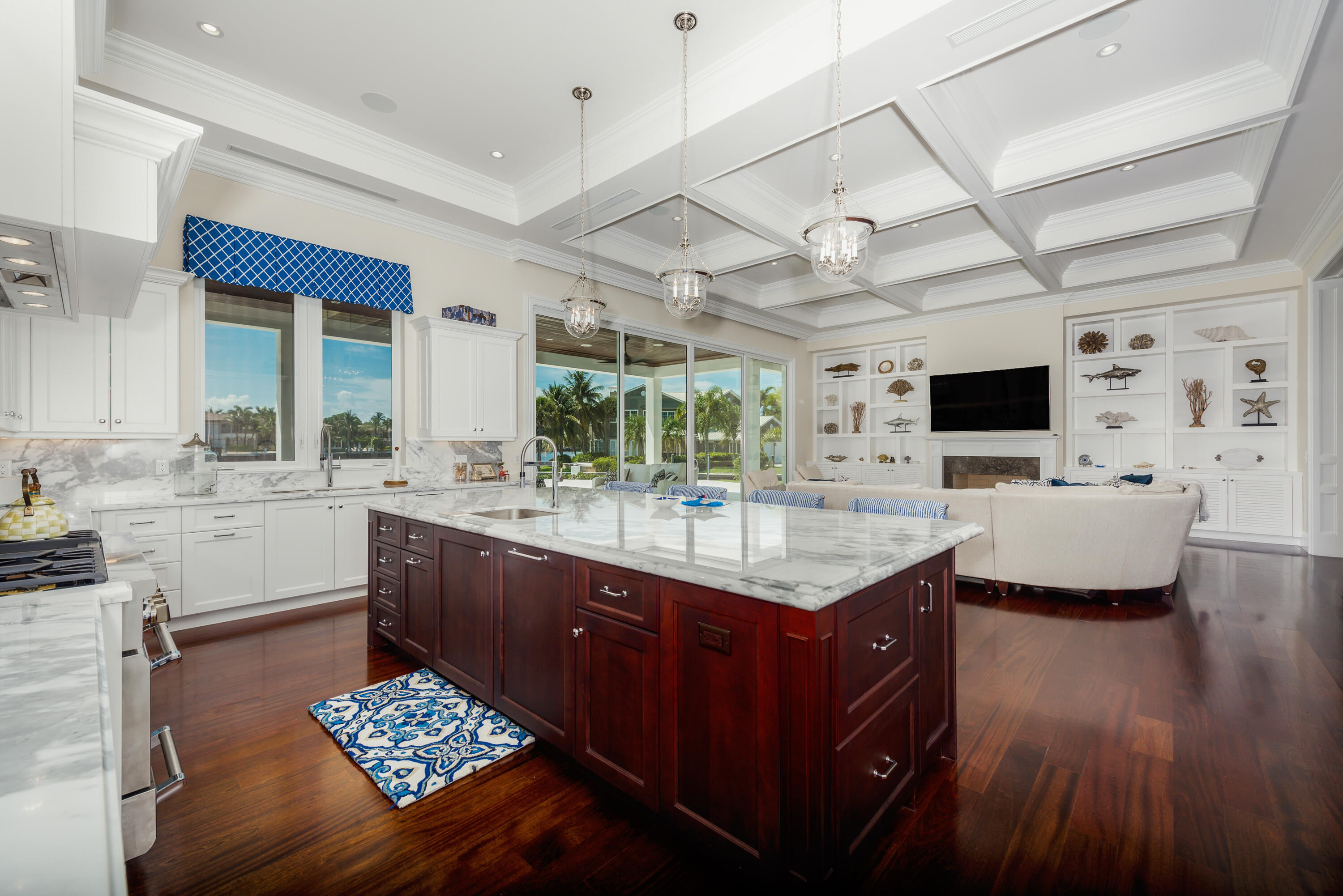 976 Cypress Drive Delray Beach, FL 33483 - Photo 13 of 38 a kitchen with stainless steel appliances kitchen island granite countertop a sink stove and wooden cabinets