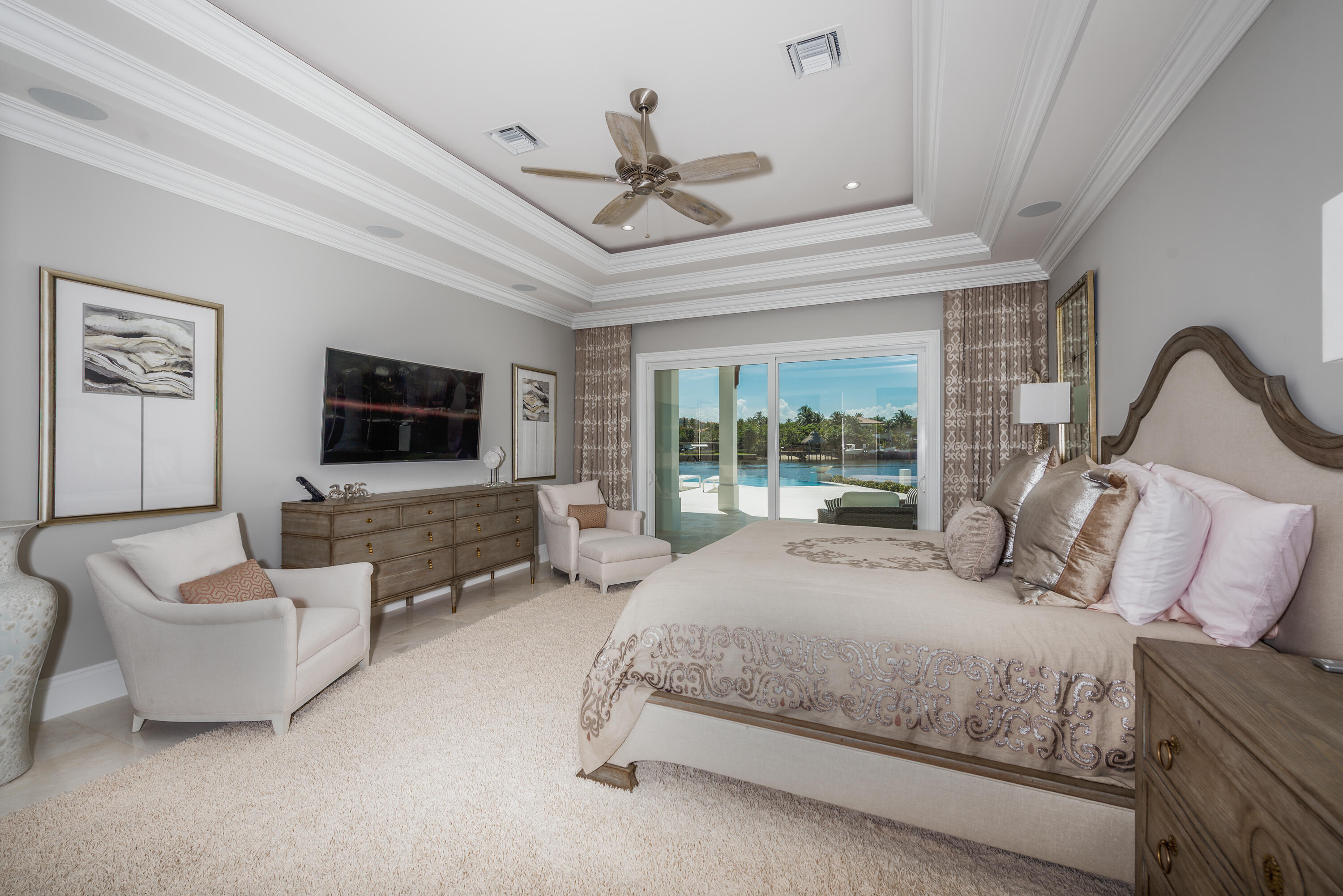 976 Cypress Drive Delray Beach, FL 33483 - Photo 23 of 38 a bedroom with a bed a couch and a flat tv screen