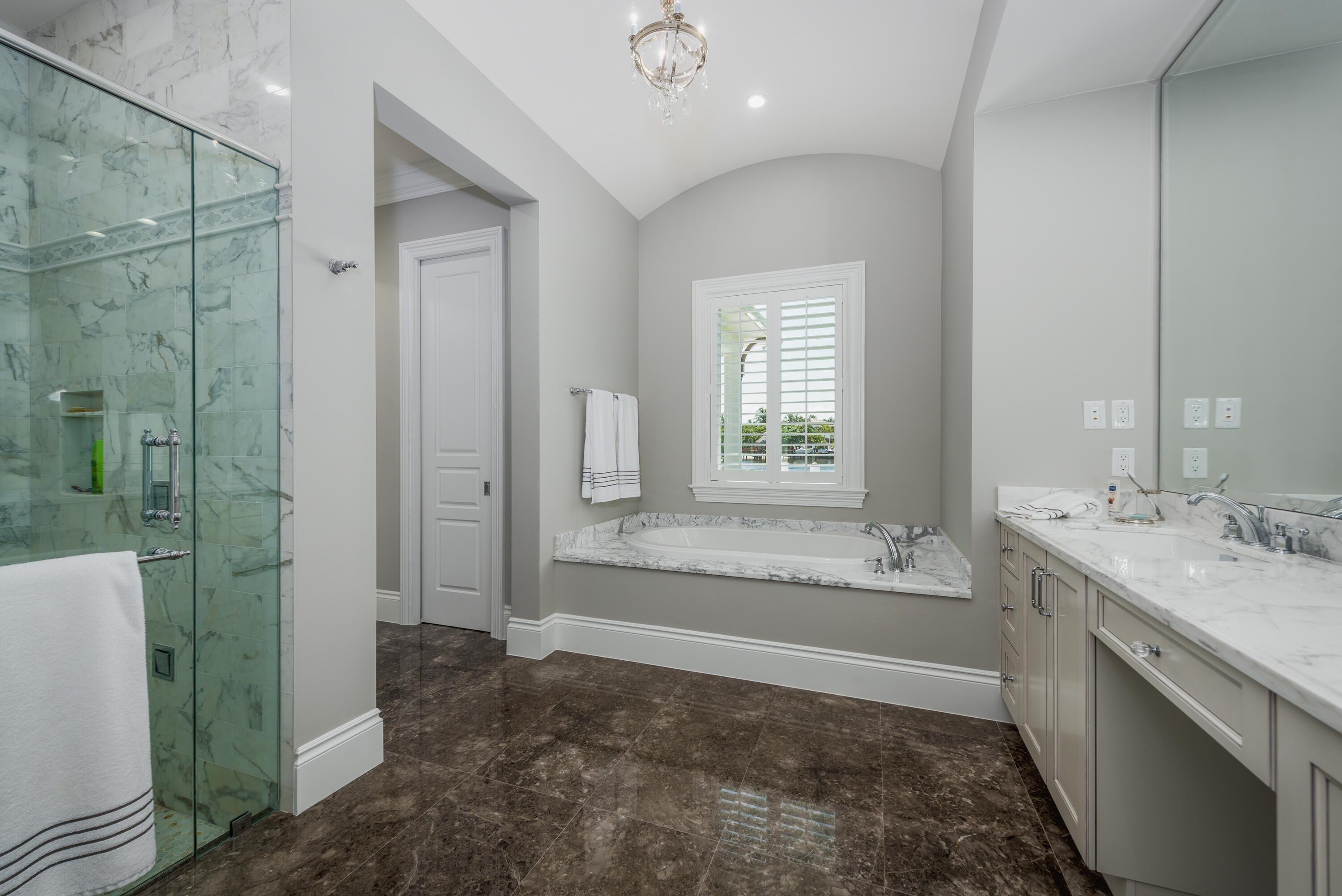 976 Cypress Drive Delray Beach, FL 33483 - Photo 24 of 38 a bathroom with a tub sink and mirror