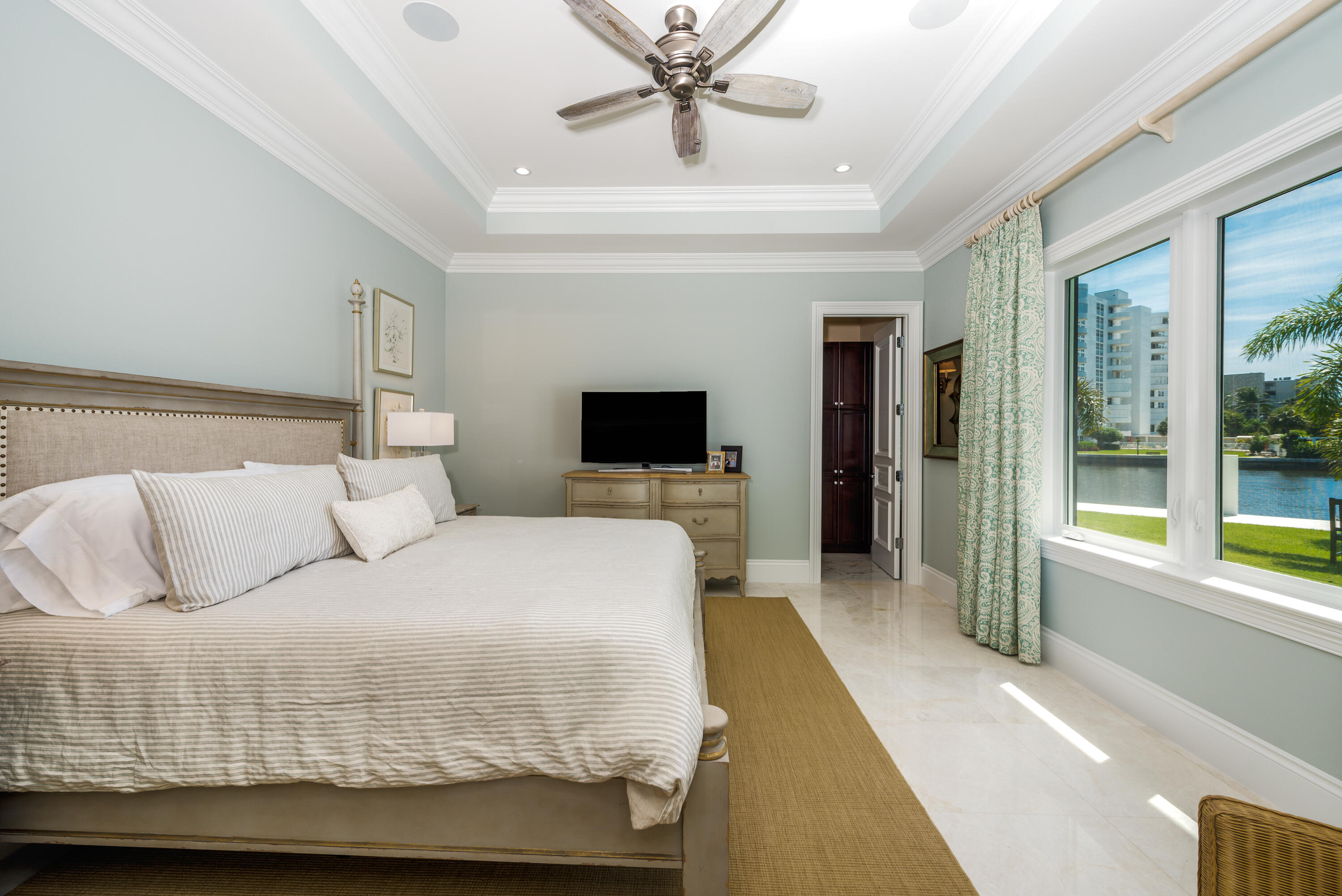 976 Cypress Drive Delray Beach, FL 33483 - Photo 27 of 38 a bedroom with a large bed and a flat screen tv