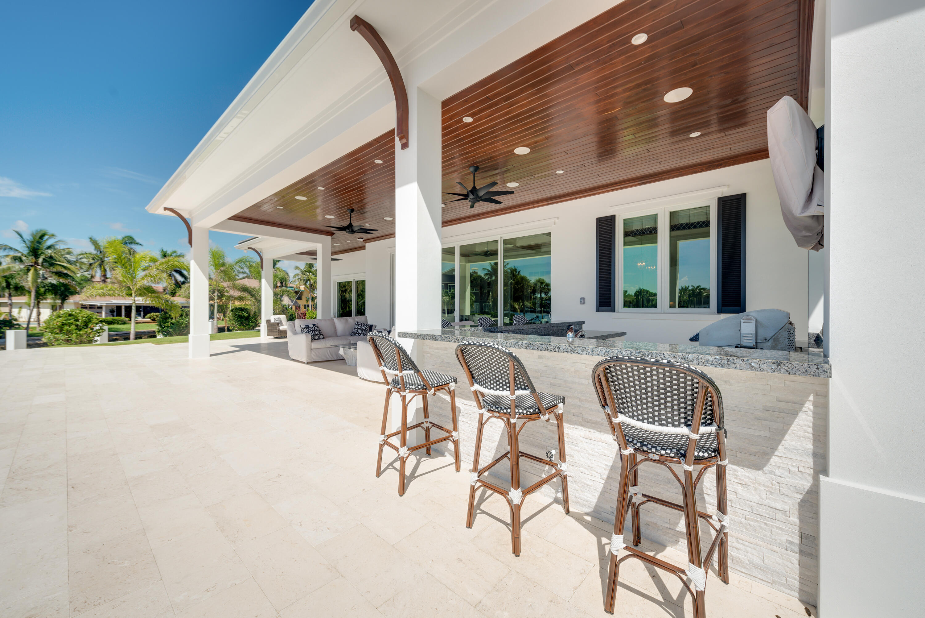 976 Cypress Drive Delray Beach, FL 33483 - Photo 33 of 38 a view of a patio with a table and chairs and potted plants