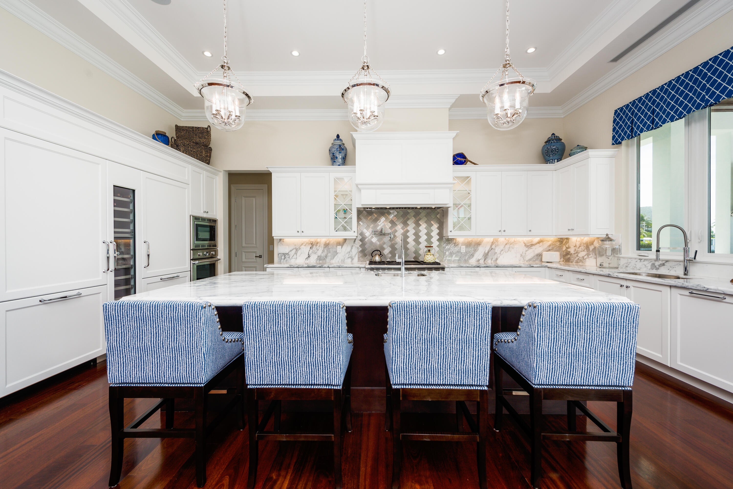 976 Cypress Drive Delray Beach, FL 33483 - Photo 9 of 38 a kitchen with a dining table chairs and wooden floor