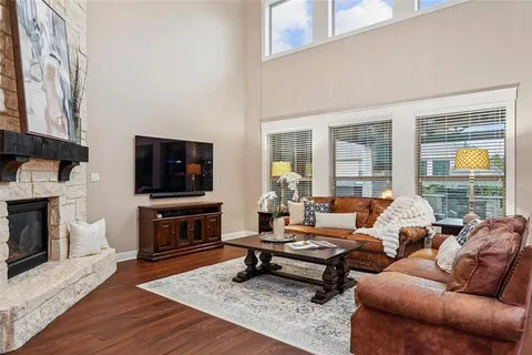 a living room with furniture a flat screen tv and a fireplace