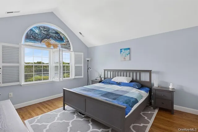 a bed sitting in a bedroom next to a window