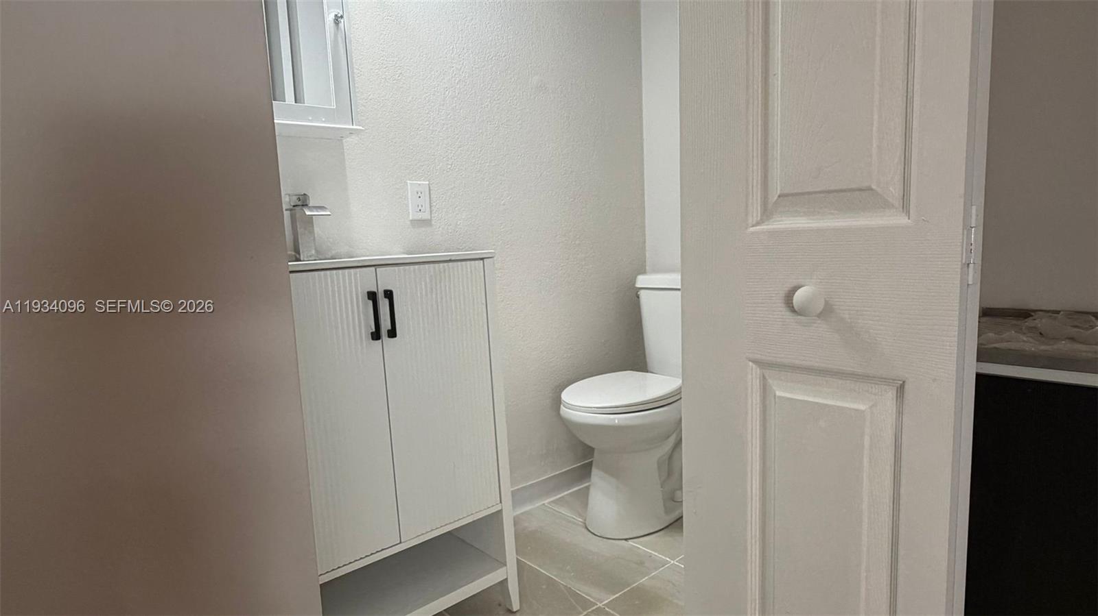 15730 Southwest 140th Street, Unit 15730 Miami, FL 33196 - Photo 5 of 10 a white toilet sitting next to a bathroom sink