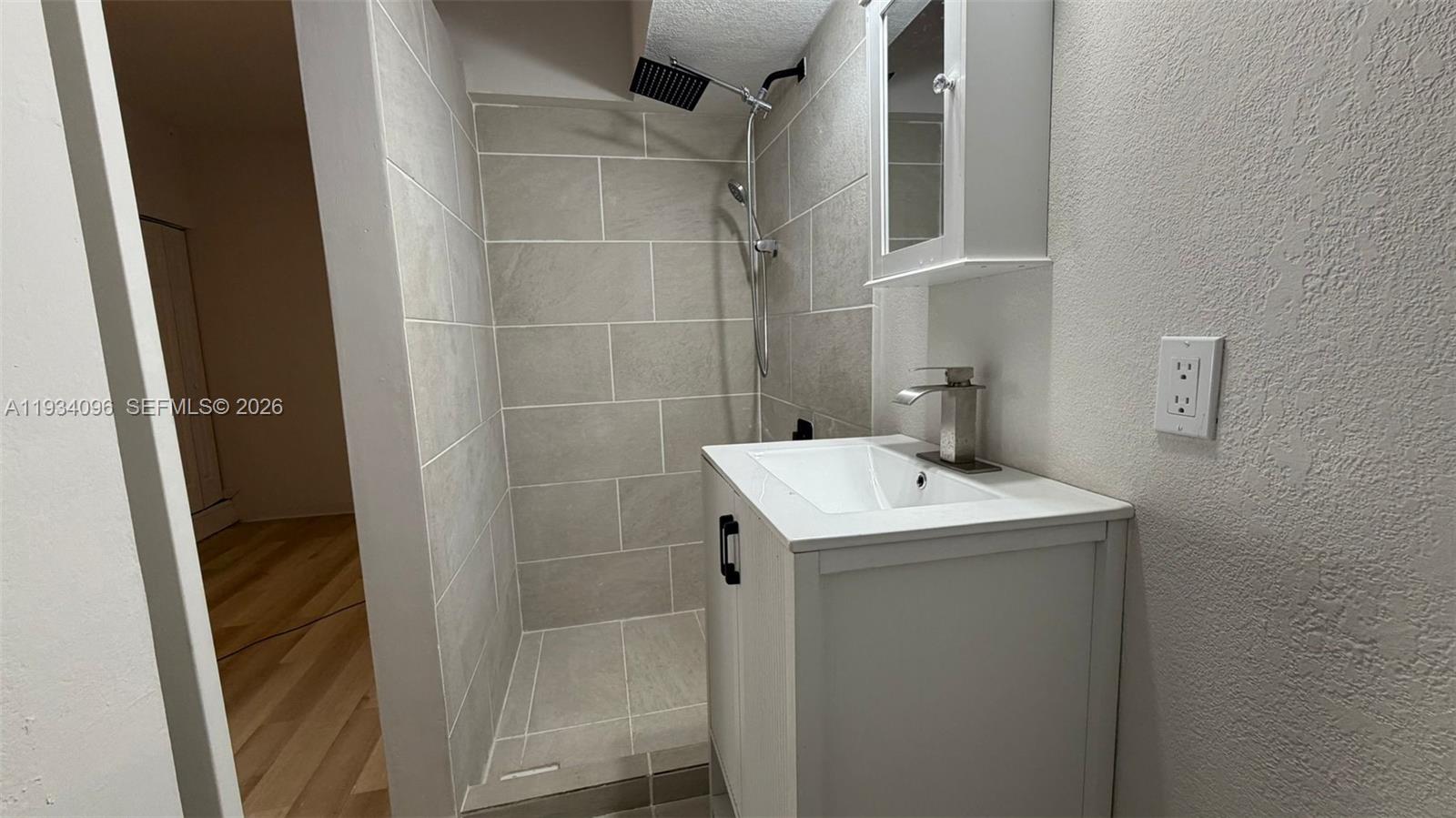 15730 Southwest 140th Street, Unit 15730 Miami, FL 33196 - Photo 6 of 10 a bathroom with a sink toilet and shower