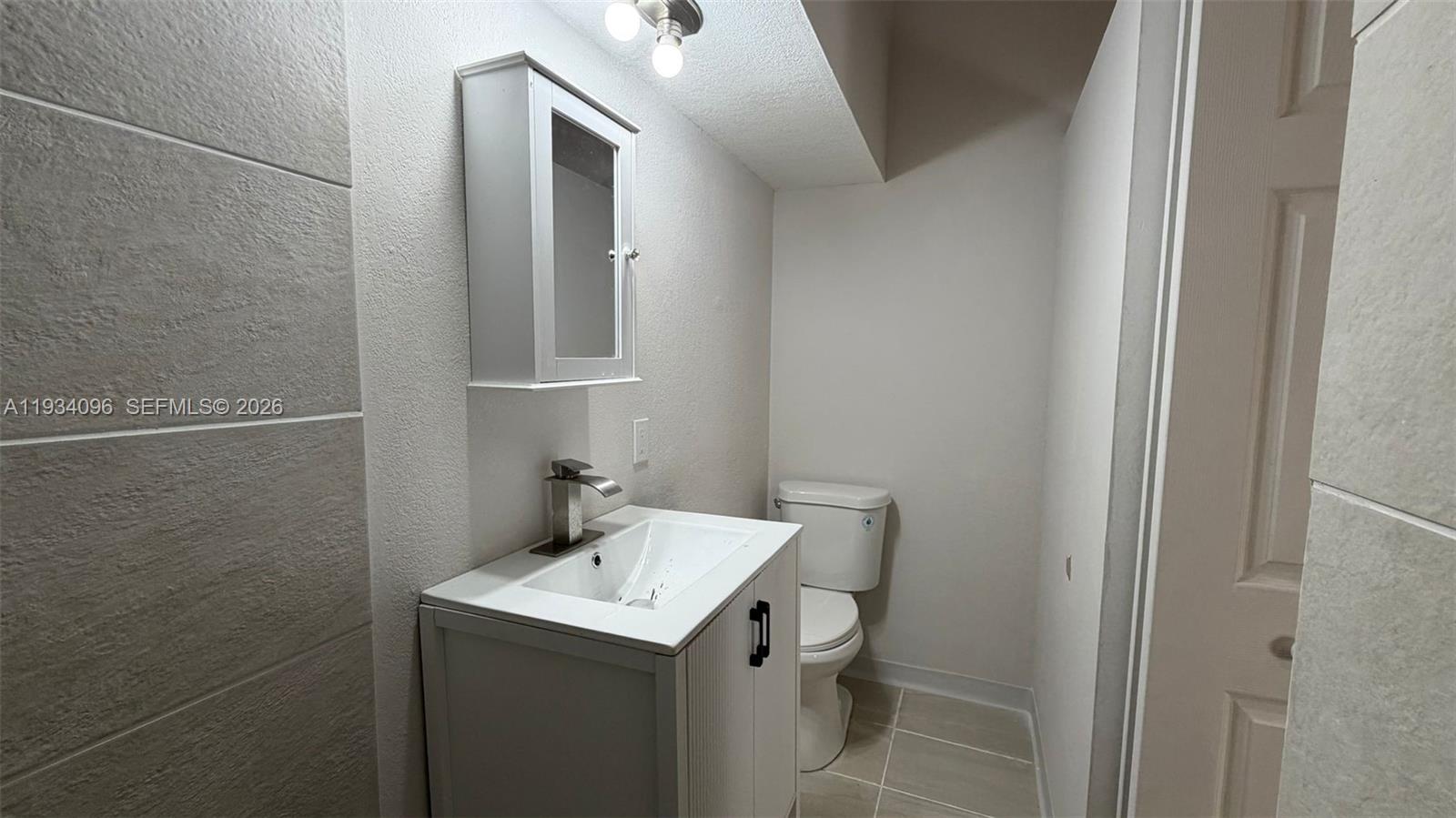 15730 Southwest 140th Street, Unit 15730 Miami, FL 33196 - Photo 7 of 10 a bathroom with a sink and mirror