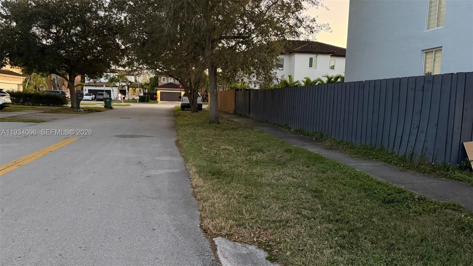 15730 Southwest 140th Street, Unit 15730 Miami, FL 33196 - Photo 10 of 10 a view of a parking space with wooden fence