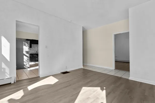 an empty room with wooden floor and closet