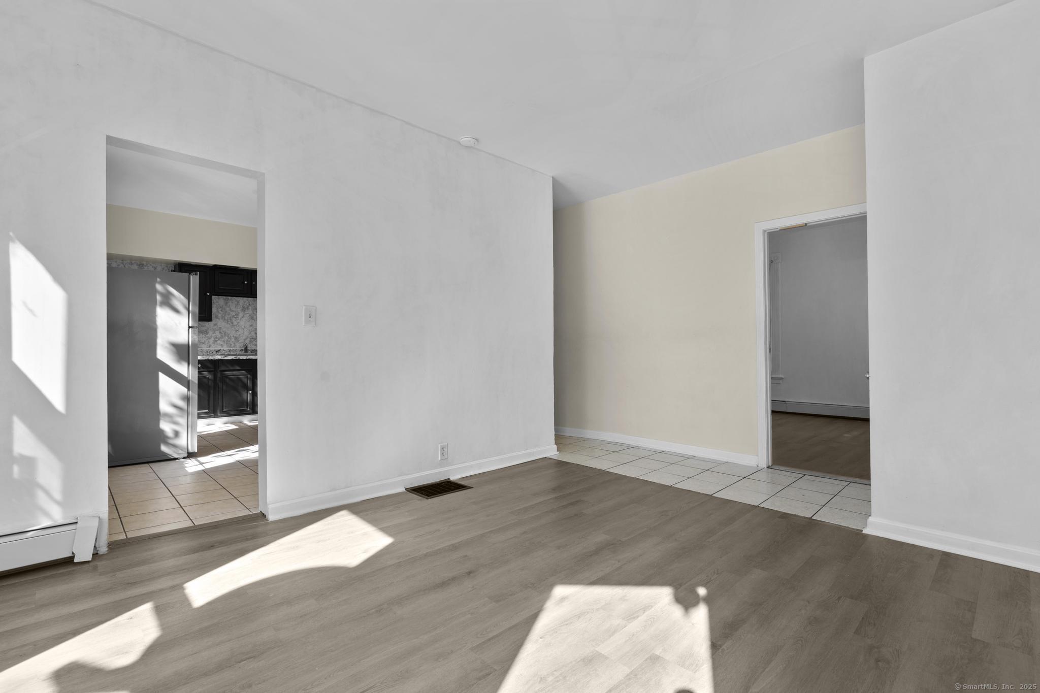 141 Crown Street, Unit 2 Meriden, CT 06450 - Photo 2 of 9 an empty room with wooden floor and closet