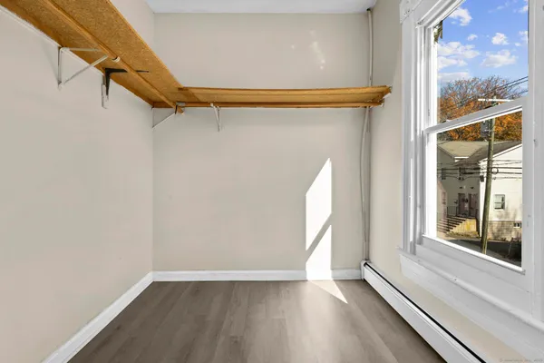 a view of a room with wooden floor and windows