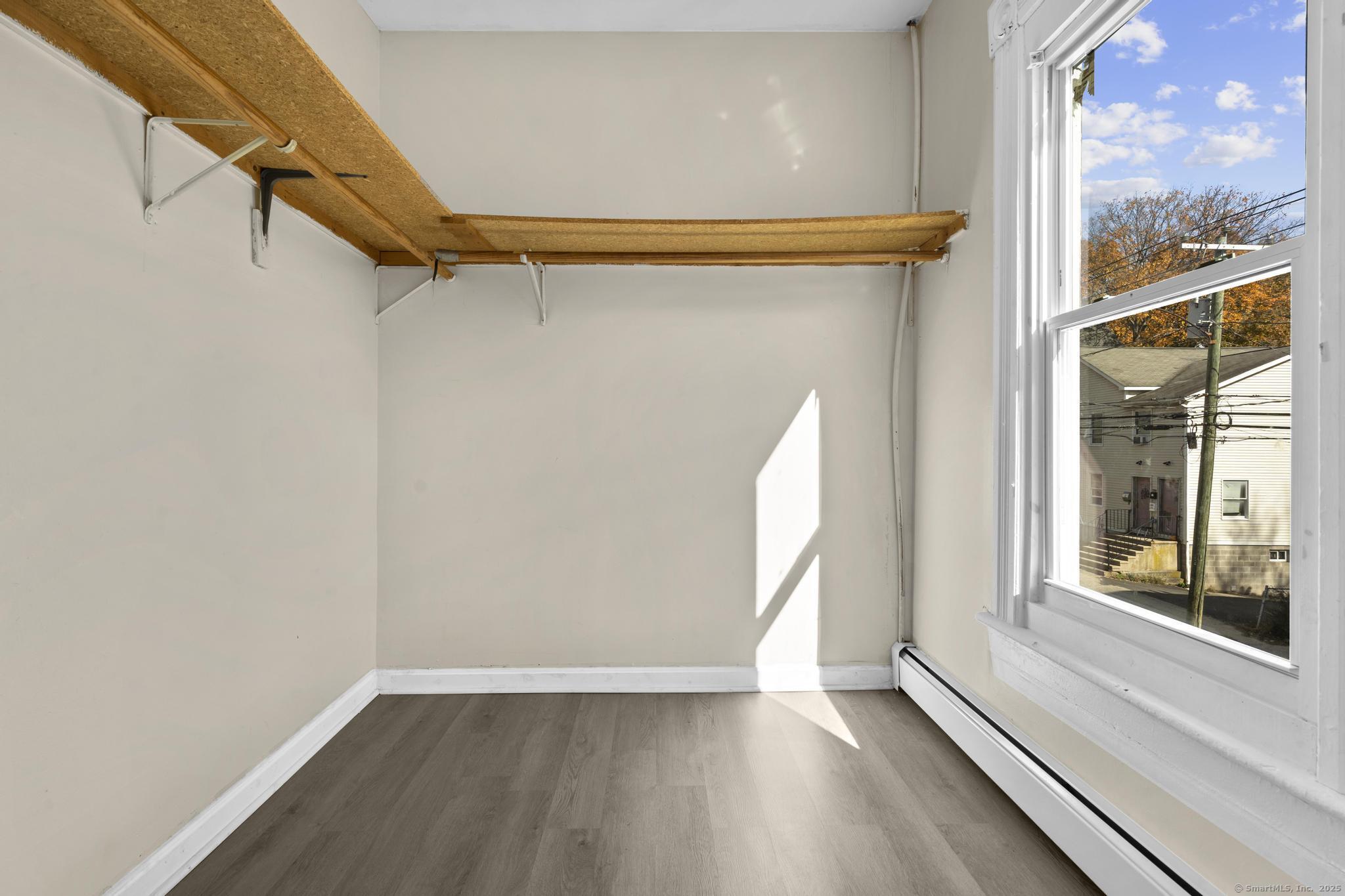 141 Crown Street, Unit 2 Meriden, CT 06450 - Photo 4 of 9 a view of a room with wooden floor and windows