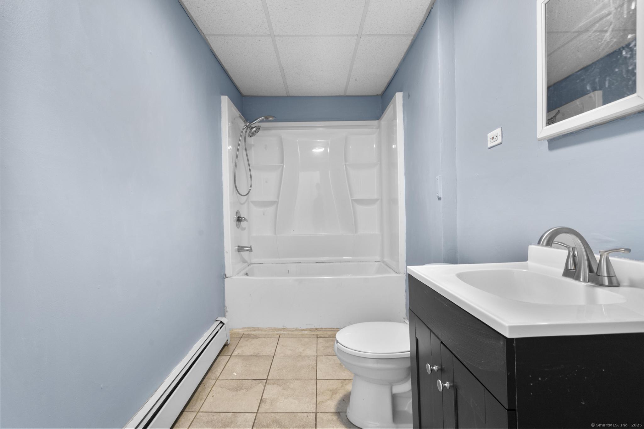 141 Crown Street, Unit 2 Meriden, CT 06450 - Photo 6 of 9 a bathroom with a sink a toilet and shower