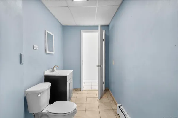a white toilet sitting next to a bathroom sink