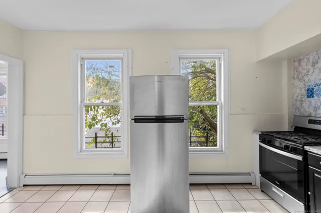 a view of kitchen with window and stainless steel appliances