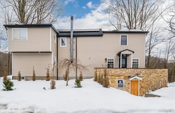 a front view of a house with snow
