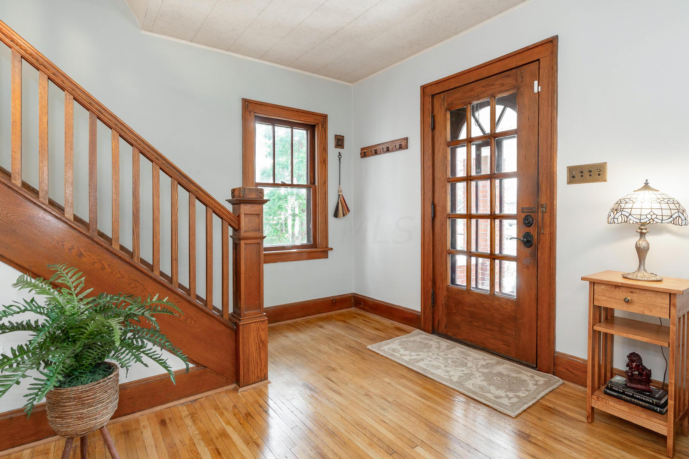 132 Chatham Road Columbus, OH 43214 - Photo 5 of 41 Beautiful front door entryway showcases the hardwood flooring, trim, and banister.