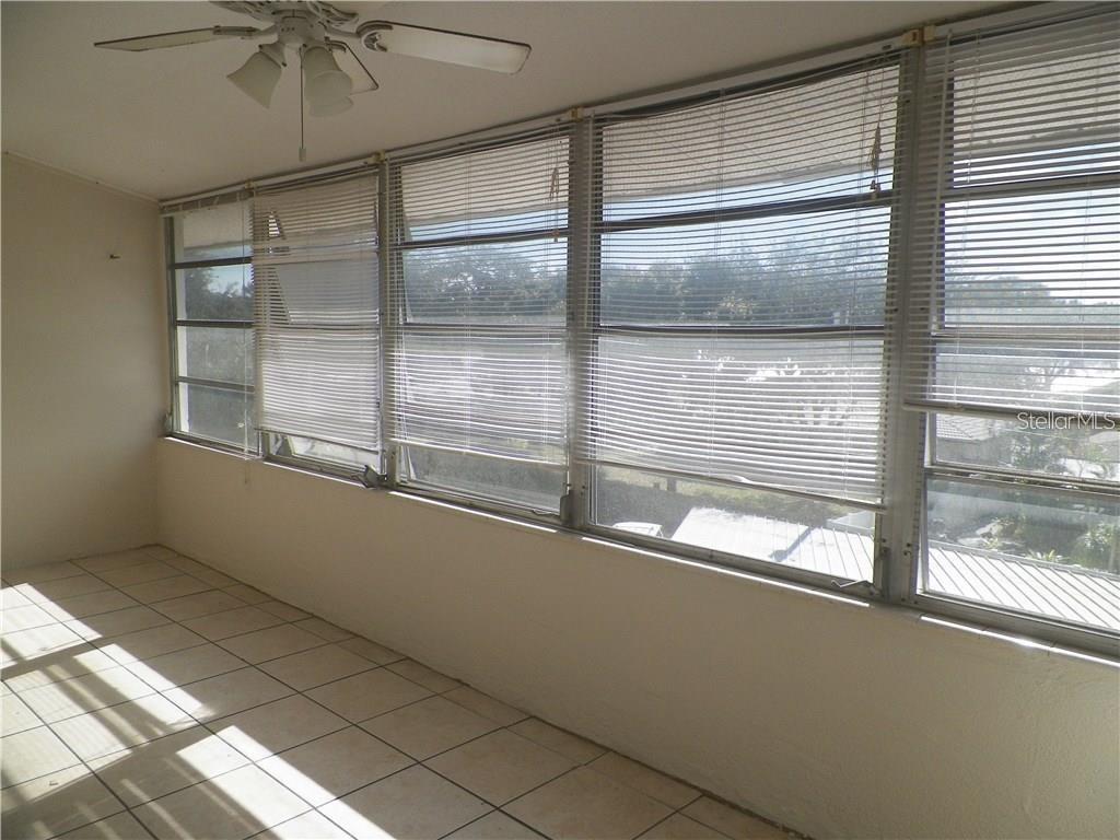 911 Washington Avenue Southwest, Unit 304 Largo, FL 33770 - Photo 11 of 26 a view of empty room with wooden floor and fan
