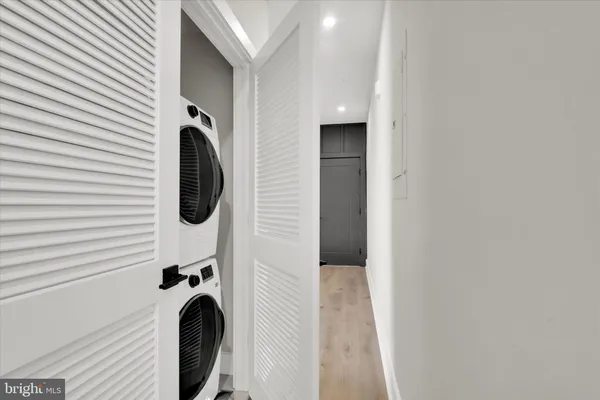 a close view of a utility room with dryer and washer