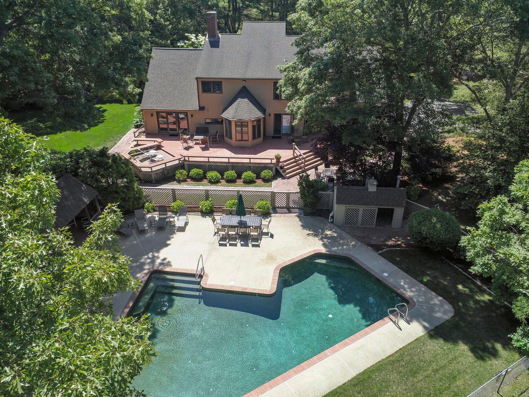 a view of a house with backyard sitting area and garden
