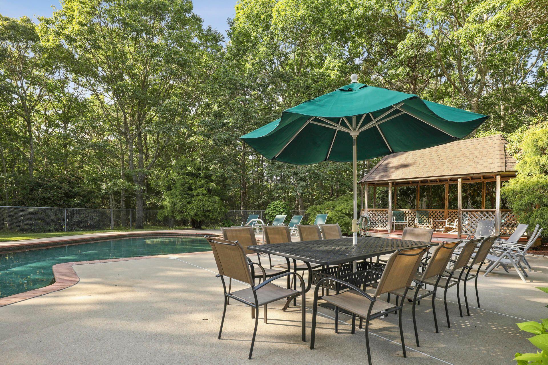 60 Smoke Valley Road Osterville, MA 02655 - Photo 8 of 12 an outdoor space with furniture and umbrella