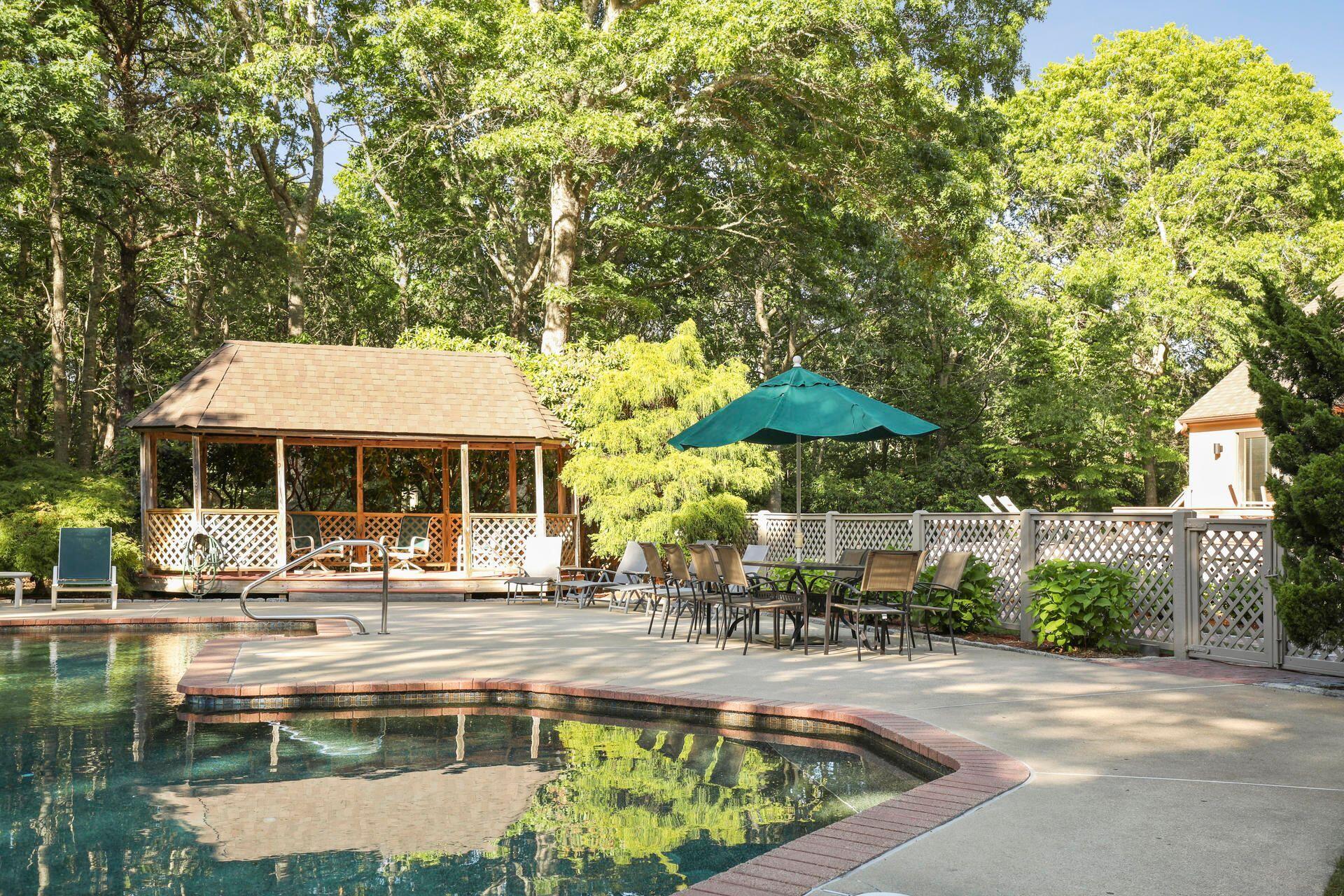 60 Smoke Valley Road Osterville, MA 02655 - Photo 9 of 12 a view of a swimming pool with a patio