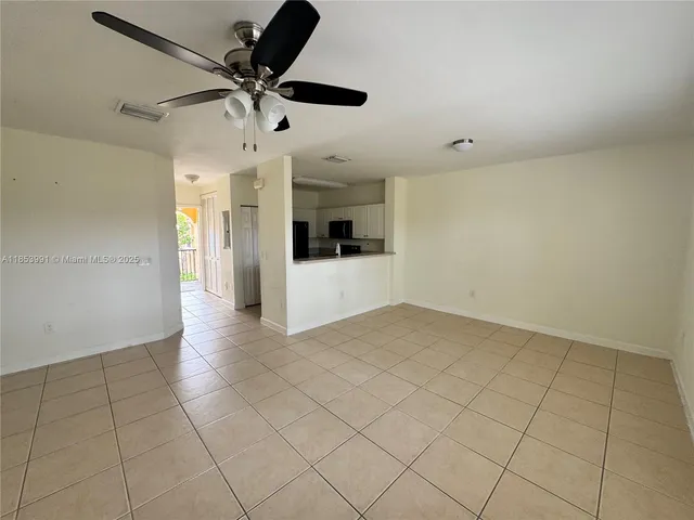 a view of a kitchen with a sink and a refrigerator