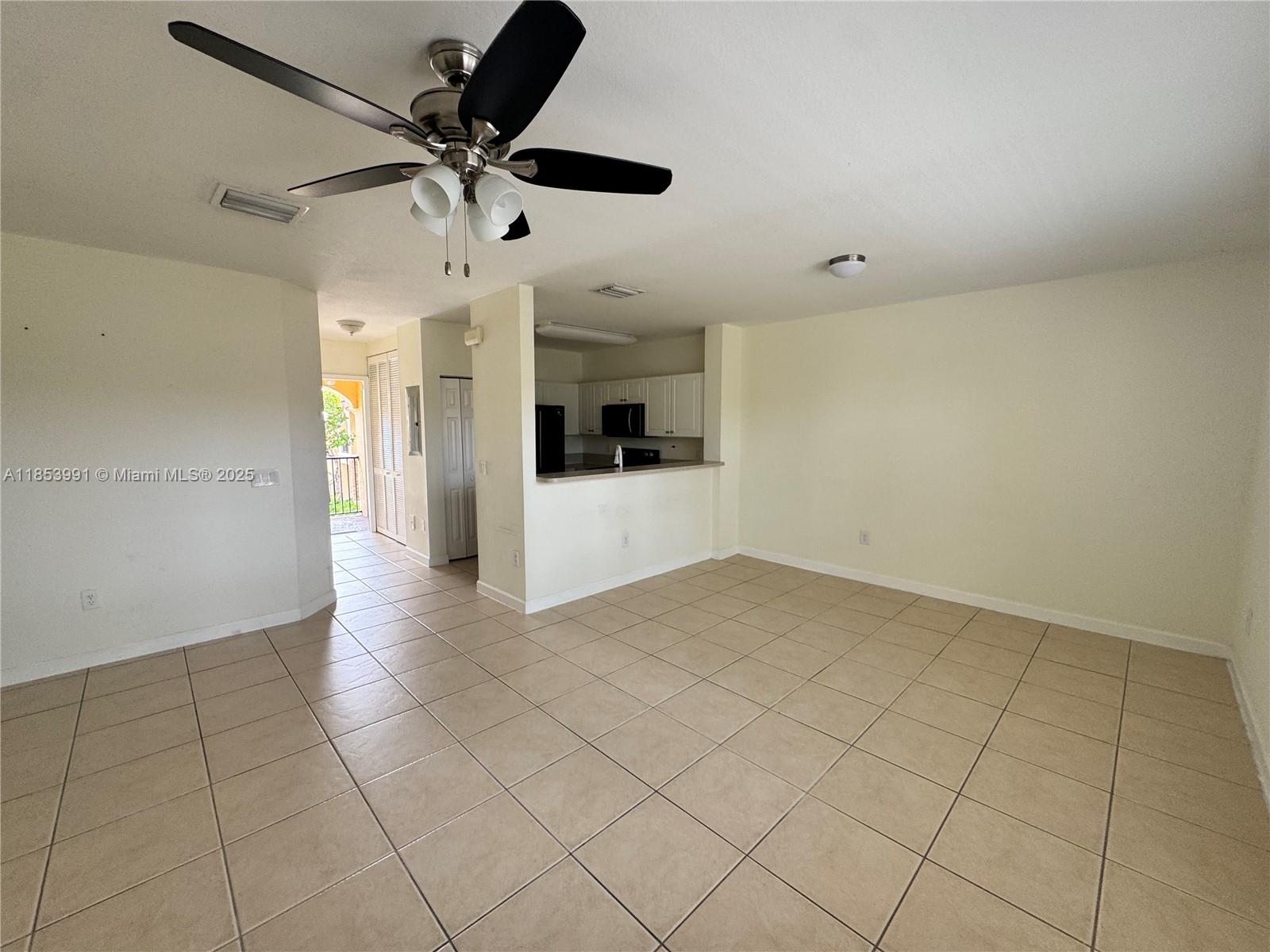 1485 Northeast 33rd Road, Unit 2121 Homestead, FL 33033 - Photo 13 of 19 a view of a kitchen with a sink and a refrigerator