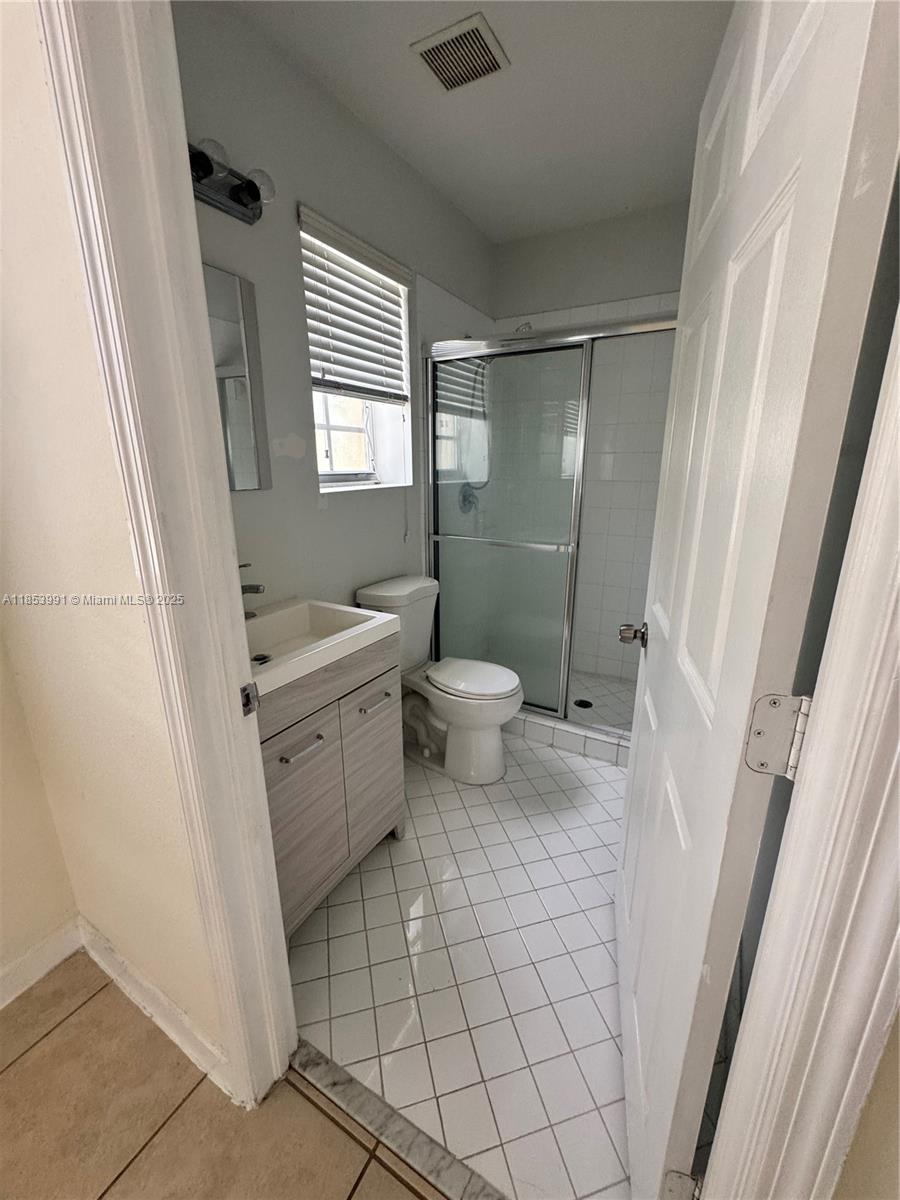 1485 Northeast 33rd Road, Unit 2121 Homestead, FL 33033 - Photo 15 of 19 a bathroom with a sink a toilet and shower