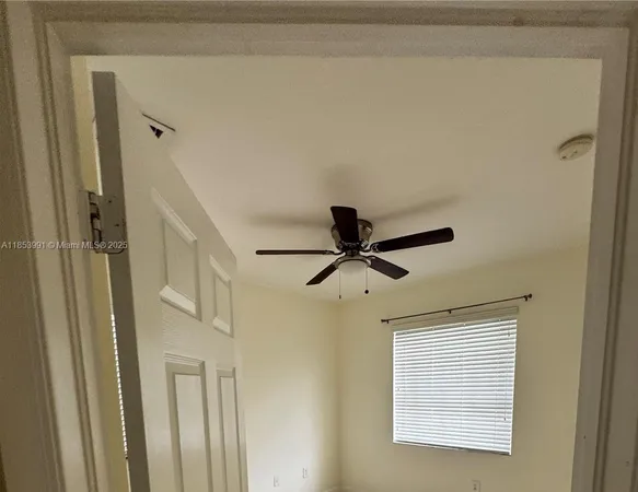 a view of a hallway with a ceiling fan