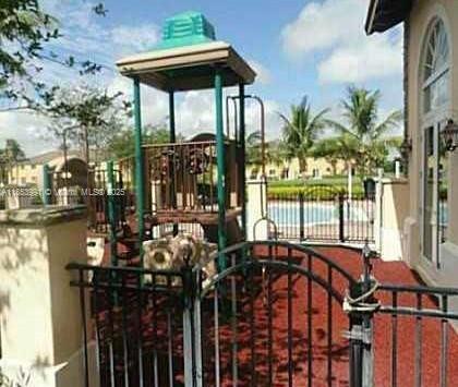 1485 Northeast 33rd Road, Unit 2121 Homestead, FL 33033 - Photo 3 of 19 a view of a patio with table and chairs potted plants with wooden floor