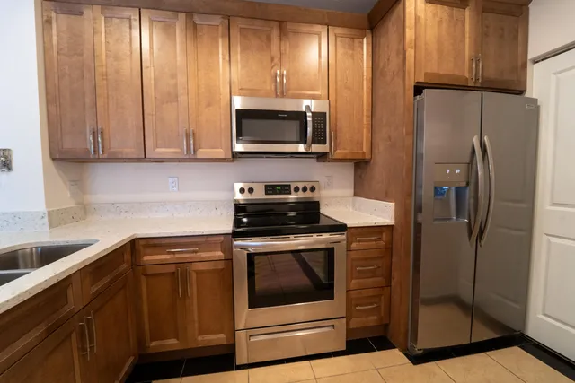 a kitchen with a refrigerator stove and microwave