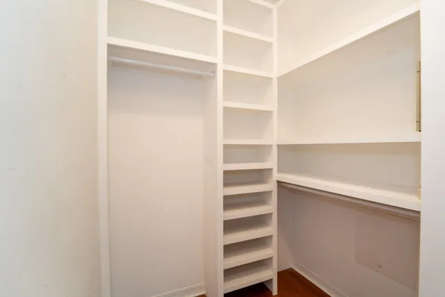 a view of walk in closet with empty racks