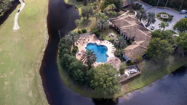 an aerial view of a house with a yard basket ball court