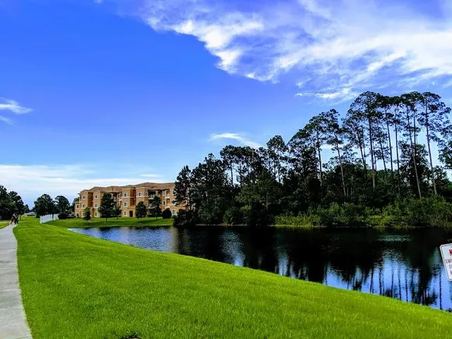 a view of residential house with outdoor space and lake