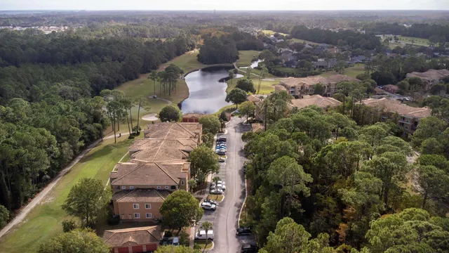 an aerial view of a house with a mountain