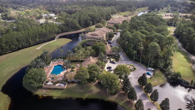 an aerial view of a house with a yard