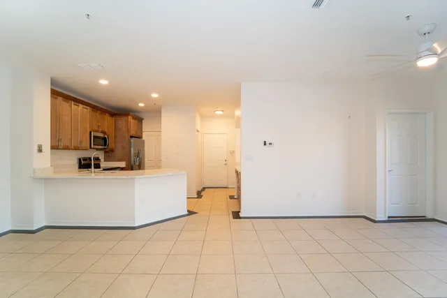 a view of kitchen with furniture and refrigerator